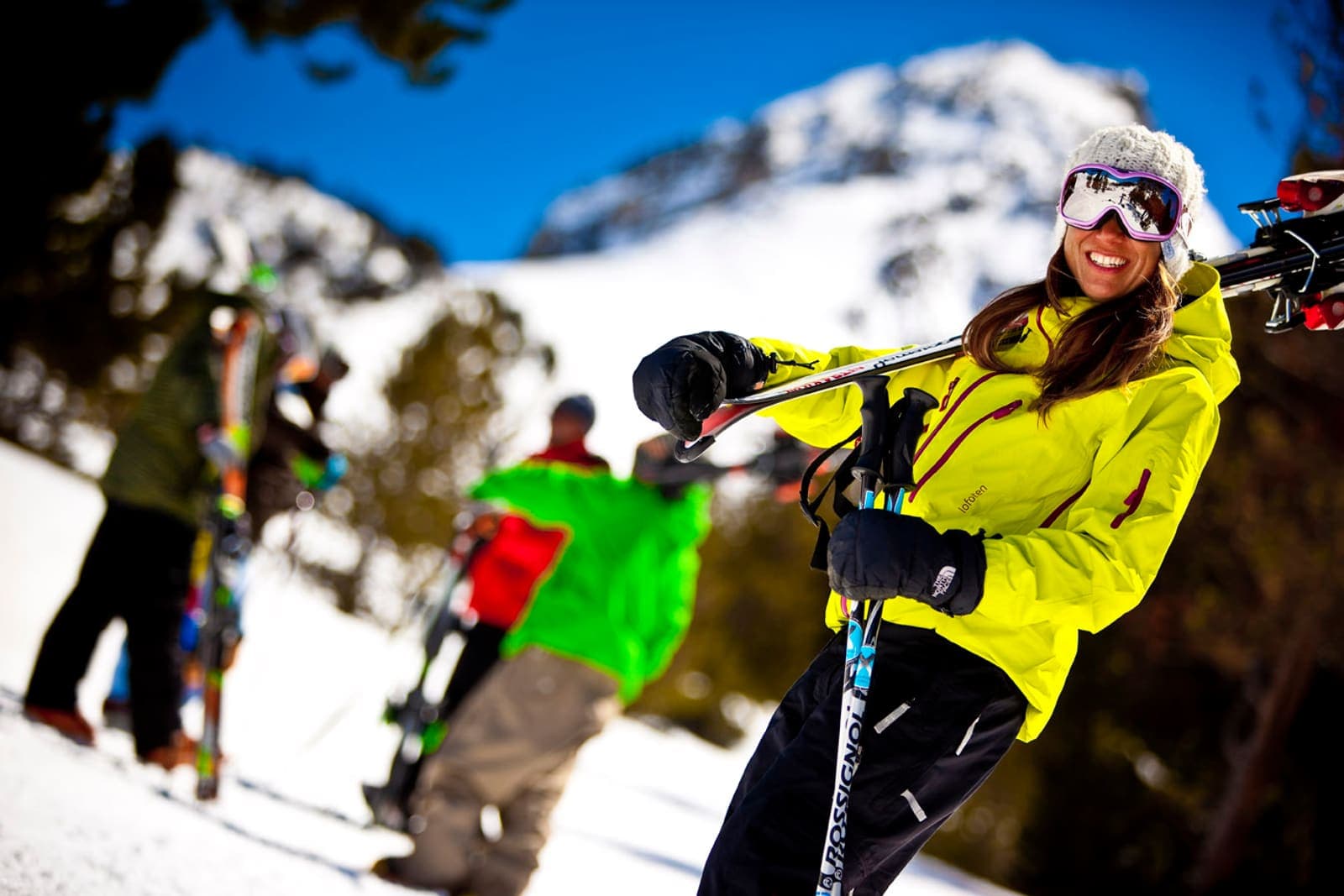 Skier carrying skis through the snow