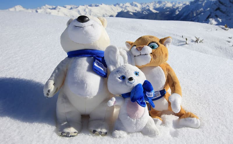 The Sochi mascots sitting in the snow