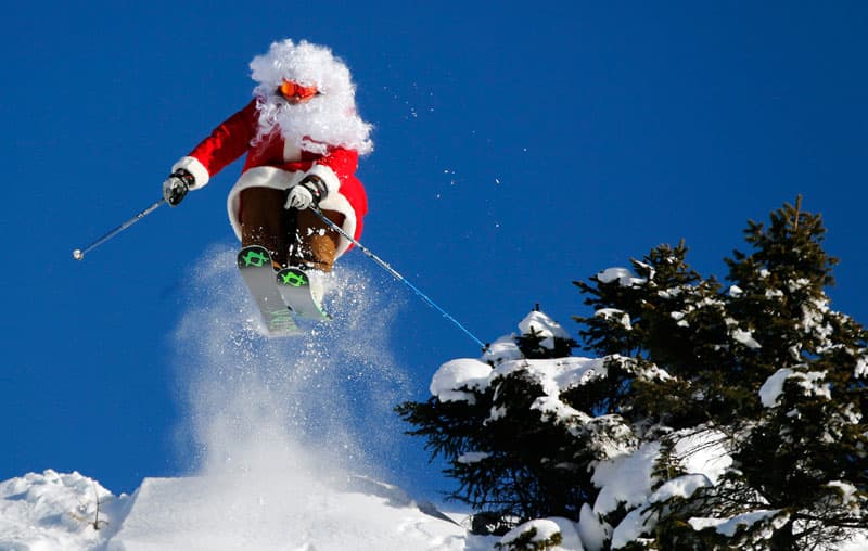 Santa on skis doing a jump