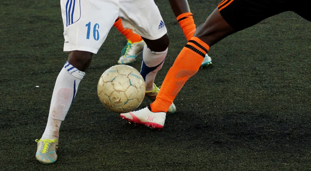 Football player's legs with football