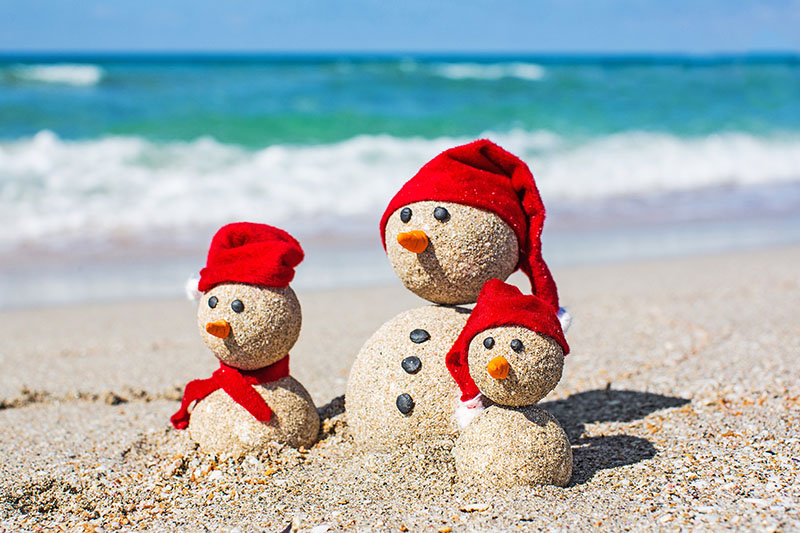 Snowmen family on a beach
